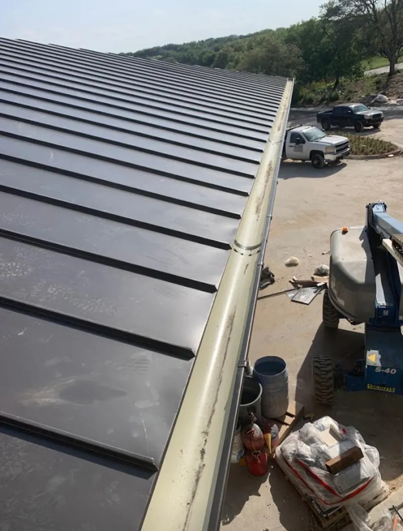 Standing seam panel and gutter detail on a metal roofing jobsite in Pulaski